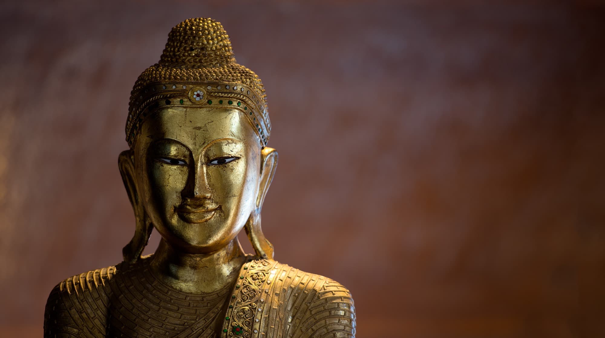A gilded Buddha figure among the treasures collected inside the house