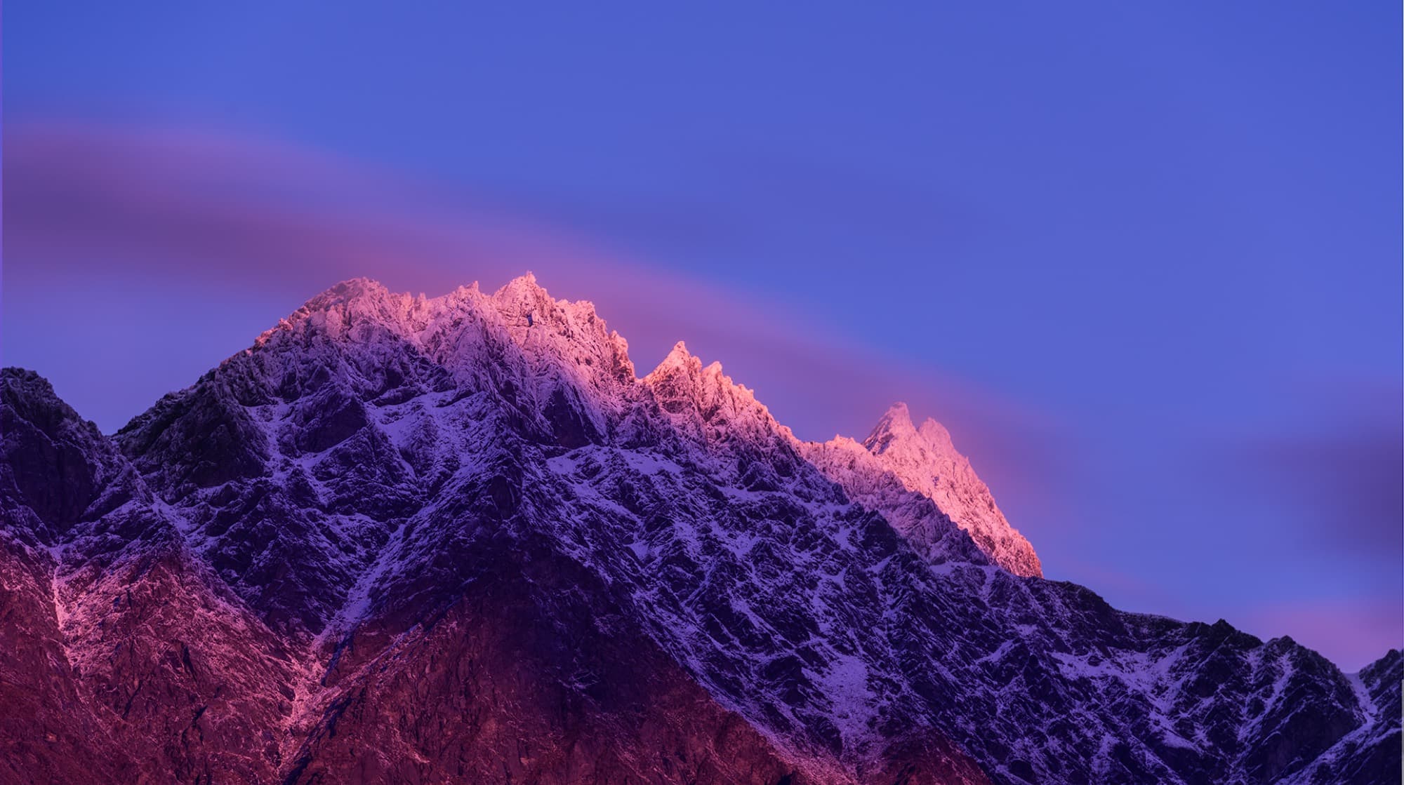 Alpenglow on the snow-covered ridgeline of the Remarkables at dusk
