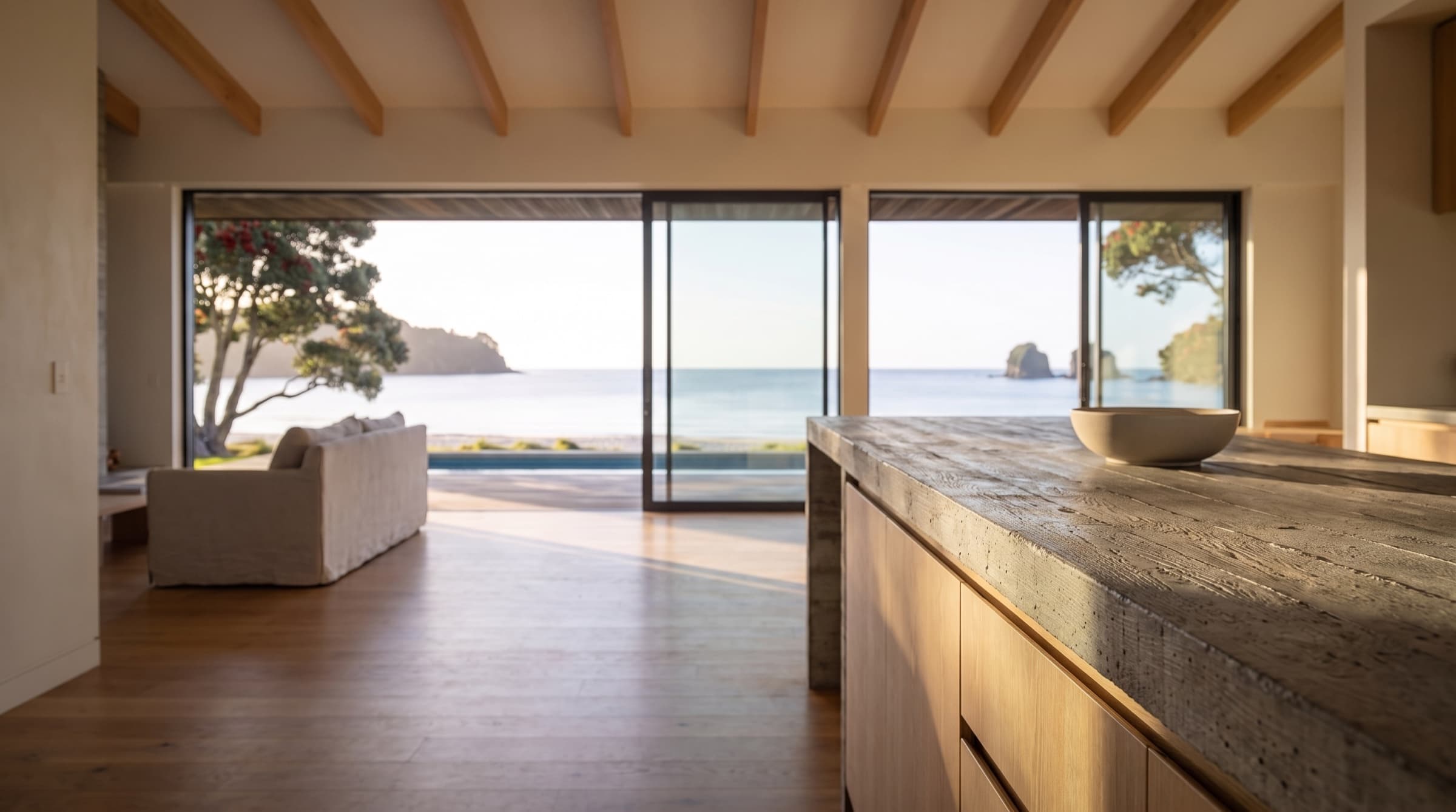 Close on the board-formed concrete kitchen island, the grain of the formwork visible along its top